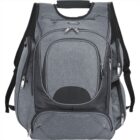 Grey backpack with multiple compartments and zippers. The design includes a large main section with smaller front and side pockets. It features padded shoulder straps and a handle at the top. Simple and modern appearance.
