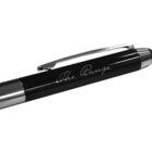 A black pen with silver accents, featuring a metal clip and the engraved text The Range on the barrel. The pen has a glossy finish and a modern design.