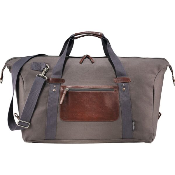 A large gray duffel bag with brown leather accents and navy blue straps. It features a front leather pocket with a zipper, a detachable adjustable shoulder strap, and two handles. The bag has metal hardware and a small side pocket.