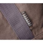 Close-up of a brown fabric bag with a textured strap. A small woven label is visible, with indistinct text in a contrasting color. The material appears durable, suggesting a sturdy construction.