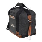 A gray fabric cooler bag with brown leather accents and black straps. It features a bottle opener attached to the front and a front pocket. Theres a logo and patch on the side, and a small pocket on top.