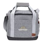 A gray, insulated cooler bag with light gray straps and a shoulder strap. It features a front pocket, a zippered top closure, and a logo with Yellow Bridge in yellow and blue on the front. Theres a brown leather patch on the lower right.