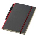 A closed black notebook with a red elastic band lies on a white surface. A black pen is attached to the notebook with a pen holder. The edges of the pages are visible on the right side.