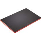 A closed black notebook with a red spine is lying on a white surface. The notebook is positioned at an angle, showcasing its flat cover and contrasting vibrant spine.