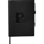 A black leather-bound notebook embossed with the words Plum Grove and a plum icon. It has a silver pen attached on the right side. A black ribbon bookmark is visible at the bottom.