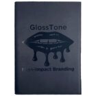 Dark notebook cover with the text GlossTone at the top and High-Impact Branding at the bottom. In between, theres an image of lips with drips extending downward.