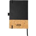 A black leather notebook with a cork bottom section, featuring a small label that reads Journal Books. The notebook has a black elastic band and ribbon bookmarks. The design is simple and modern.