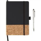 A notebook with a black and cork cover, secured by a black elastic band, lies next to a silver pen with a black tip. The notebook has a loop for holding the pen.