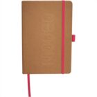 A brown hardcover notebook embossed with a vertical brand name. It features a pink elastic closure and a matching pink ribbon bookmark. The notebook also has a pink pen loop. The background is plain white.