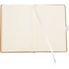 Open notebook with lined pages and a white ribbon bookmark down the center. The notebook has a brown cover and is laid on a light surface.