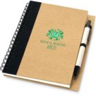 A spiral-bound notebook with a brown cover featuring a green logo for F&H Fresh & Healthy Juices. A black and white pen is attached to the side of the notebook.
