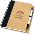 A brown spiral-bound notebook with a black spine and a pen attached to the side. The cover features a logo with the text House of Books underneath a roof-like design.