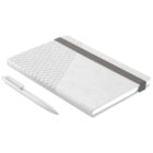 A sleek notebook with a geometric pattern on the cover lies alongside a matching pen. The notebook is secured with an elastic band and has a simple, modern design, predominantly in shades of gray and white.