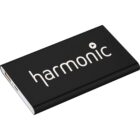 A slim, black portable charger with the word harmonic and a play button icon printed in white on its surface. The charger has visible USB ports on one side.