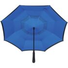 A blue umbrella with a black handle is open, viewed from below. It features a unique pattern of small black holes arranged in a circular design on the fabric.