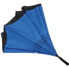A blue umbrella is inverted, showcasing its inside-out design. It features a black handle and black trim along the edges. There are two rows of black polka dots near the middle of the fabric.