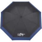 A top view of a blue and black umbrella with eight panels. The word Royalty and a crown logo are printed in white on one panel.