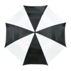 A large, open umbrella viewed from above, featuring alternating black and white panels arranged in a classic pattern. The umbrella has a simple and symmetrical design.