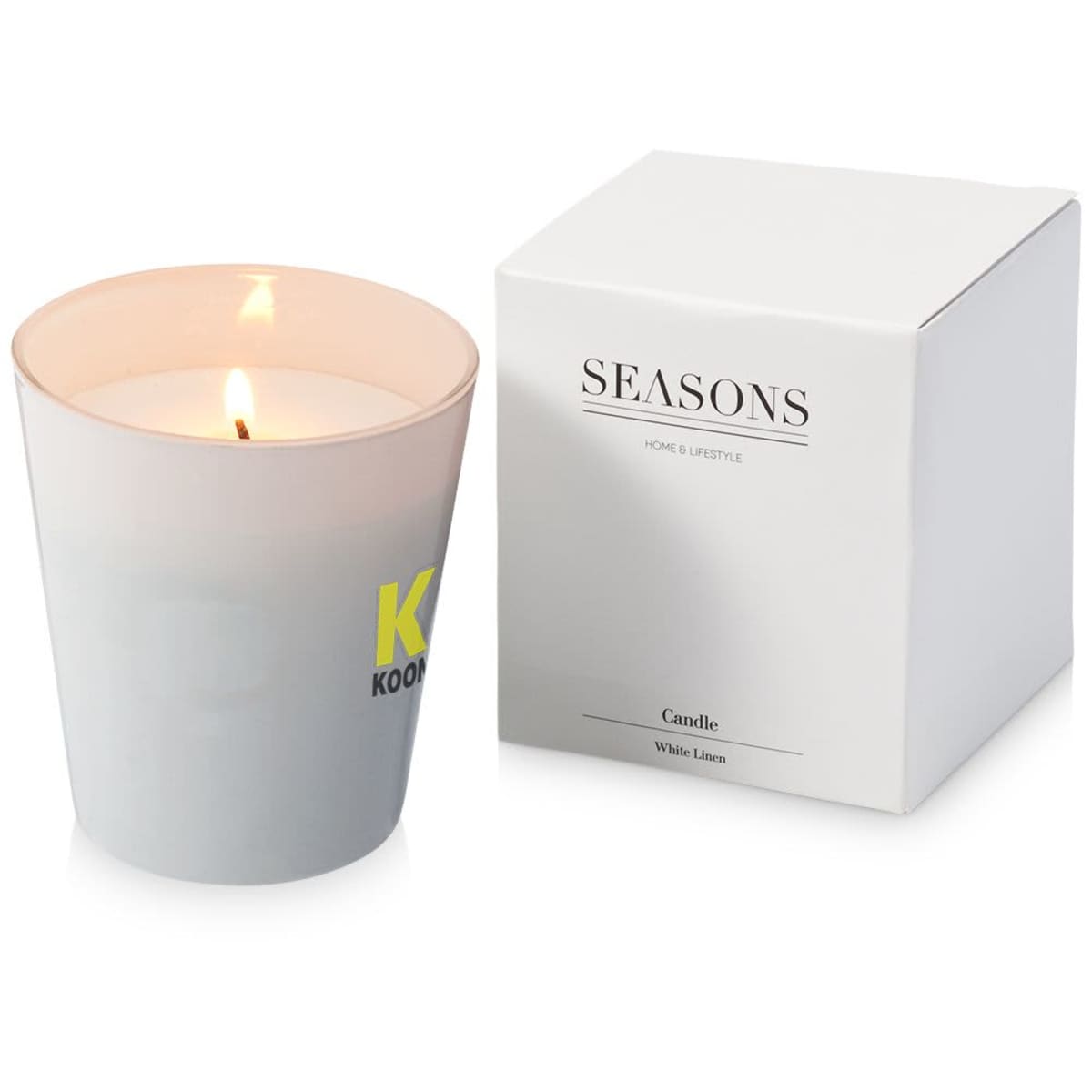 Lit white candle in a frosted glass holder with the letter K on it. Next to it is a white box labeled SEASONS Home & Lifestyle Candle White Linen.