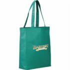 Green tote bag with two handles and the words Harvest Favorites printed in yellow and white on the front. The bag has a simple, rectangular design and is set against a plain white background.