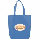 Blue tote bag with two handles, featuring a white oval design on the front with the text Autumn Treasures in brown and decorative leaves in red, green, and orange around it.