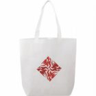 A white tote bag with a red geometric pattern resembling an intricate, abstract design in the center. It has long handles for carrying.