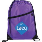 A purple drawstring backpack with a black zipper pocket on the front. It features the taeq logo in blue and white. The corners are reinforced with black material and eyelets for the drawstrings.