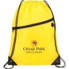 Yellow drawstring backpack with a black front zipper pocket. The bag features the Caesar Park Hotels & Resorts logo in black, with a posh emblem above it. Black drawstrings and corner reinforcements are visible.