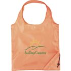 A reusable orange tote bag with the Sun Deep Cosmetics logo, featuring a stylized sun rising over green hills. The bag has a drawstring pouch attached at the bottom corner.