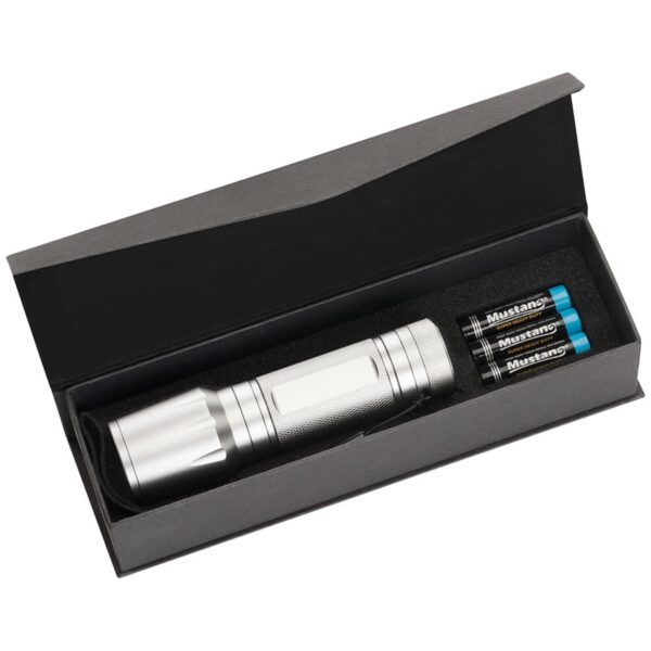 Silver flashlight in an open black box, accompanied by three cylindrical blue and silver batteries labeled Mustang on the right.