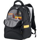 A black backpack with an open front pocket showing orange and silver pens, notebooks, and sunglasses. The side mesh pocket holds a yellow item. A laptop is partially visible in the main compartment.