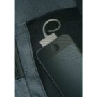 A smartphone with a protective textured cover is partially inserted in a dark gray fabric pocket. A USB cable is connected to the phone, with the other end emerging from the pocket.