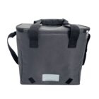 A black insulated cooler bag with carrying handles and a shoulder strap. The bag has a rectangular shape with a zippered top and a small rectangular patch near the bottom.