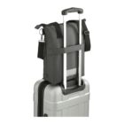 Small black bag attached to the handle of a silver rolling suitcase against a white background.