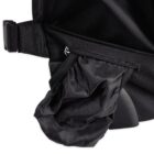Close-up of a black backpack with a side zipper pocket partially open, revealing a crumpled black umbrella being pulled out. The fabric appears to be waterproof with a textured finish, and there is a plastic buckle near the pocket.