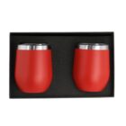 Two red stainless steel tumblers with silver rims are placed in a black box lined with foam.