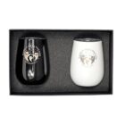 A black and a white insulated tumbler with lids, featuring a Family Healthcare Services logo. They are placed side by side in a black gift box with foam padding.