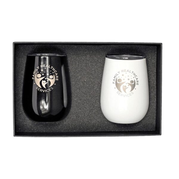 A gift box containing two insulated cups, one black and one white. Each cup has a logo with a tree and the text Family Healthcare Services printed on it. The cups are secured in black foam padding.