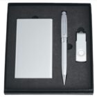 Gift set containing a metal business card holder, a silver pen, and a USB flash drive in a black foam-lined box.