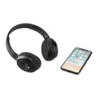Black over-ear wireless headphones are positioned next to a smartphone with a visible app grid on the screen. The headphones have BONE and PAW text on the sides. The phone has a thin black frame and icons in rows.