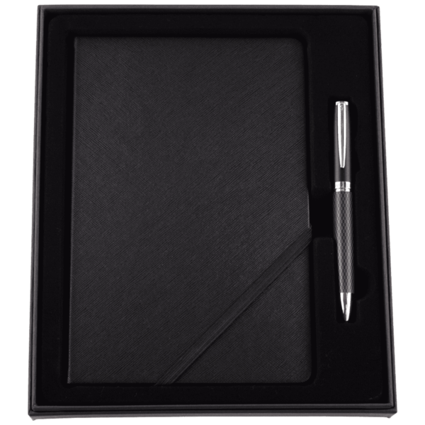 A black notebook and a matching pen with silver accents are set in a black gift box. The notebook has a textured cover, and the pen rests in a groove on the right side of the box.