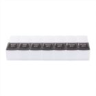A weekly pill organizer with seven compartments labeled for each day of the week, from Saturday to Sunday, with pm on each lid. The lids are black with white lettering.