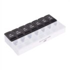 A weekly pill organizer with compartments labeled for each day of the week, Sunday to Saturday. The lids are black with white text indicating AM and PM, and the base is translucent white with Olivia Bloom printed on it.