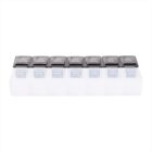 A pill organizer with seven compartments, each labeled with a day of the week from Sunday to Saturday. Each compartment is divided into two sections labeled am and pm. The lids are transparent with gray covers.