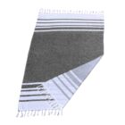 A folded woven towel with alternating dark grey and white stripes and fringe on the edges. The towel is displayed on a white background.