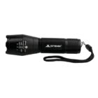 Black tactical flashlight with adjustable zoom and wrist strap. The flashlight body has a textured grip and is labeled with adjustment settings and the brand Trek.