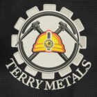 Logo featuring a hard hat with a flashlight and crossed hammers, surrounded by a gear. The text Terry Metals is written below. The design is on a textured black background.