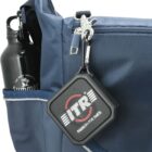Close-up of a blue backpack with a black water bottle labeled Summer in the side pocket. A black and white ITR keychain hangs from the zipper pull on the front pocket.