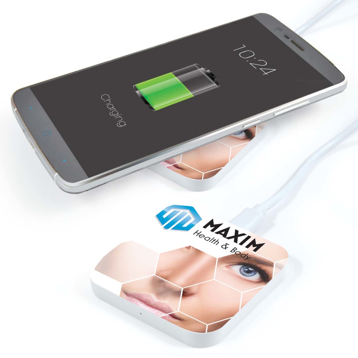 Smartphone wirelessly charging on a pad with a womans face and text MAXIM Health & Body.