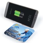 Phone charging on wireless pad with solar tech advertisement.